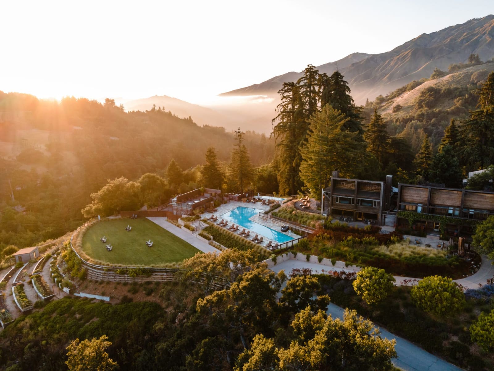 Aerial view of Ventana at sunset with the pool, meadow lawn and Santa Lucia mountains